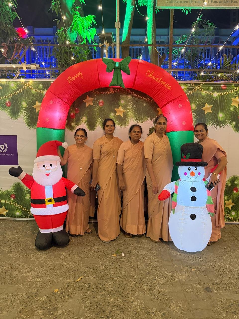 Community gathering beneath the Christmas arch