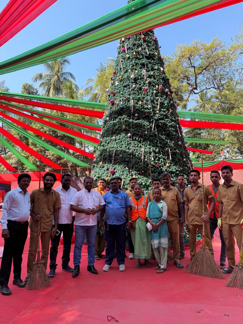 Community gathering around a Christmas tree